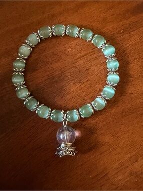Seafoam Green Cat Eye Stretch Bracelet with a Clear Crystal Ball Charm